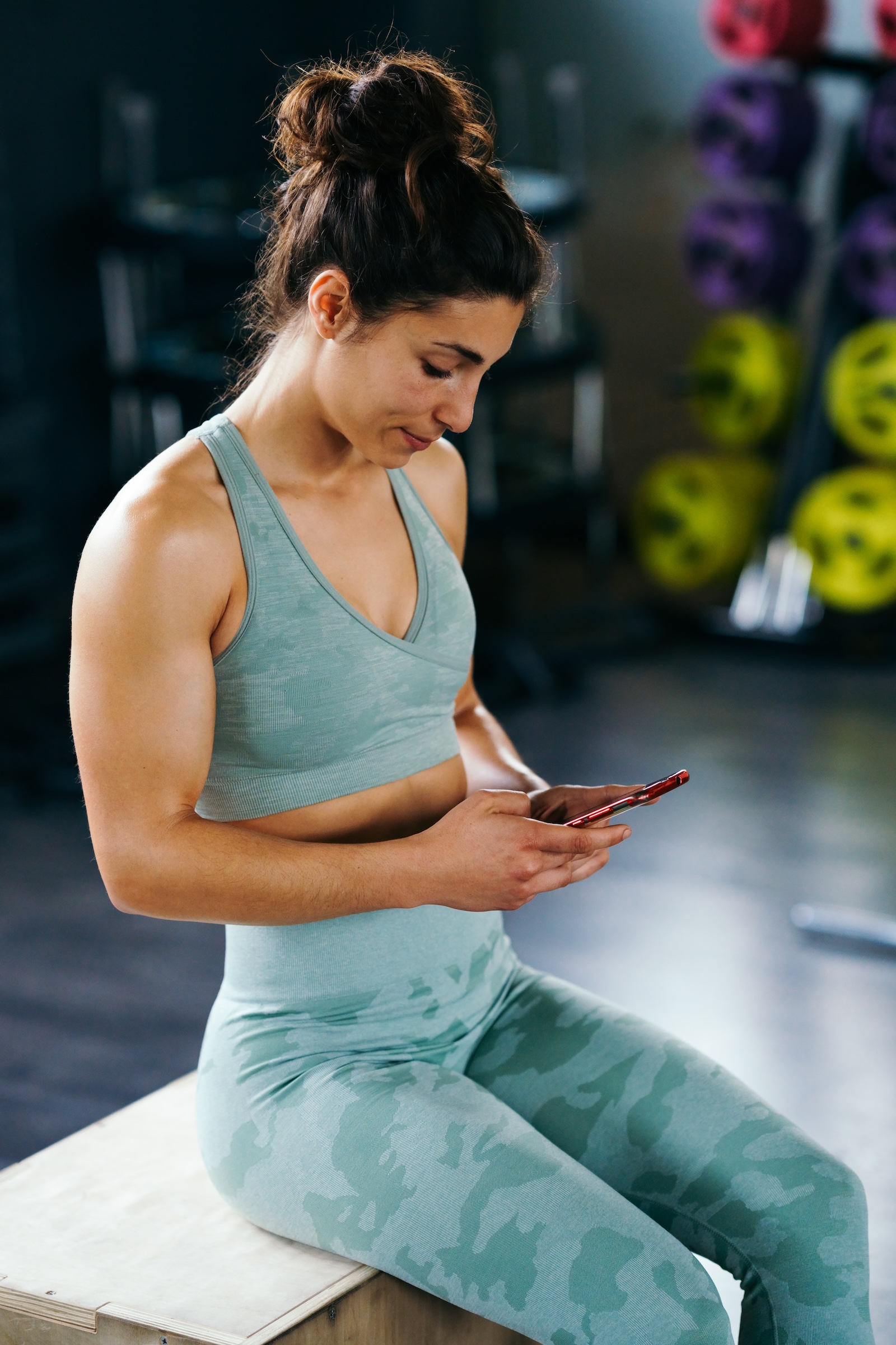 Diverse group fitness class — dumbbell workout in a bright studio